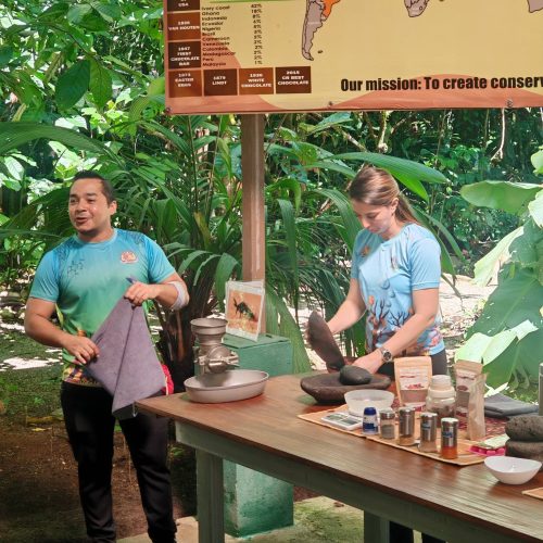 Two guides presenting the chocolate process at the tasting table