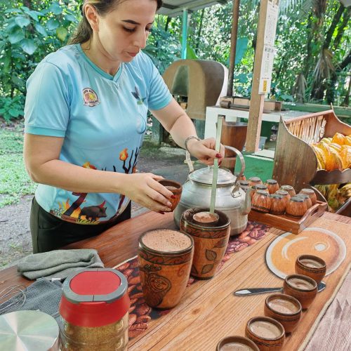 Guide preparing traditional hot chocolate at the Best Chocolate tour in Sarapiquí