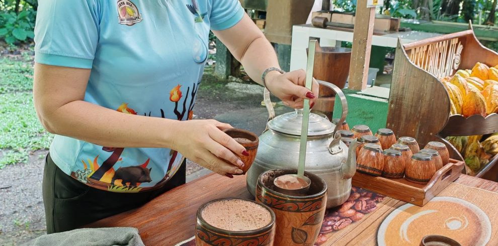 Guide preparing traditional hot chocolate at the Best Chocolate tour in Sarapiquí